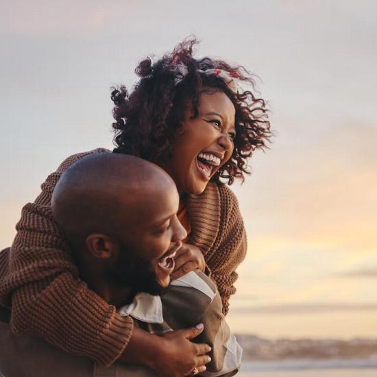 Young couple smiling at sunset